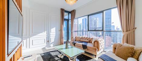 Premium Apartment, 1 Bedroom, Non Smoking, City View | Living area | 49-inch Smart TV with cable channels, TV, streaming services