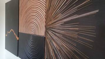 A modern art piece with concentric circles and radiating lines on a black background.