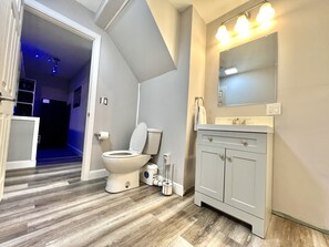 Shower, hair dryer, towels, toilet paper