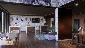 A modern reception area with patterned walls, a reception desk, seating, and a large window. - Mercure Sibiu Arsenal (Sibiu)