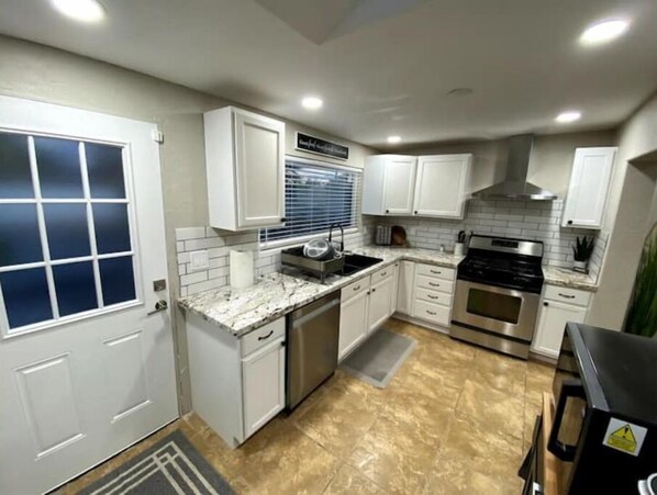 Enjoy cooking in this well-equipped kitchen with a sink, stove, and countertop.