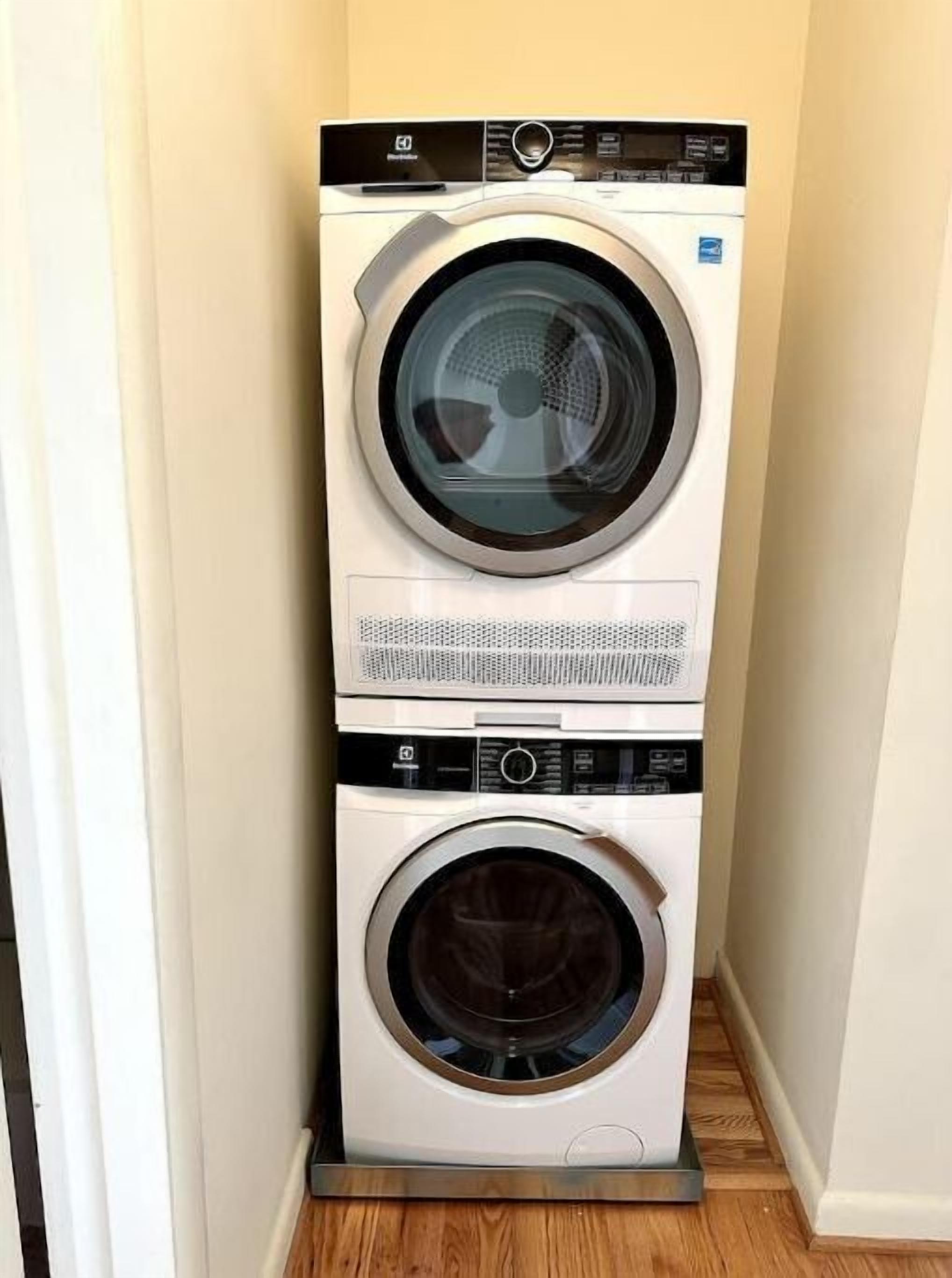 A stacked washer and dryer unit in a corner.