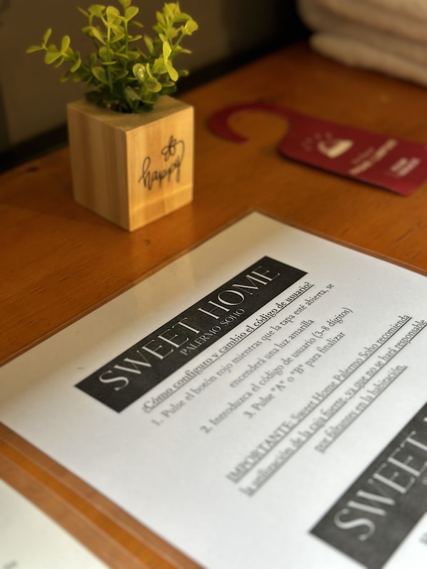 A menu with the title "SWEET HOME" and a wooden planter with a plant. - Sweet Home Palermo Soho Hostel (Buenos Aires)