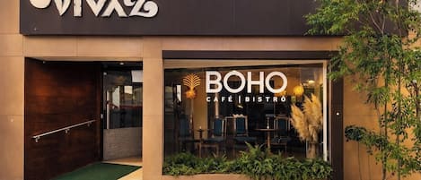 A boutique hotel named VivaZ with a visible entrance and a Boho Café & Bistro sign.
