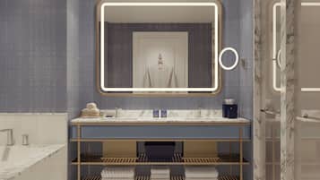 A modern bathroom with a large mirror, built-in shelves, and a towel rack.