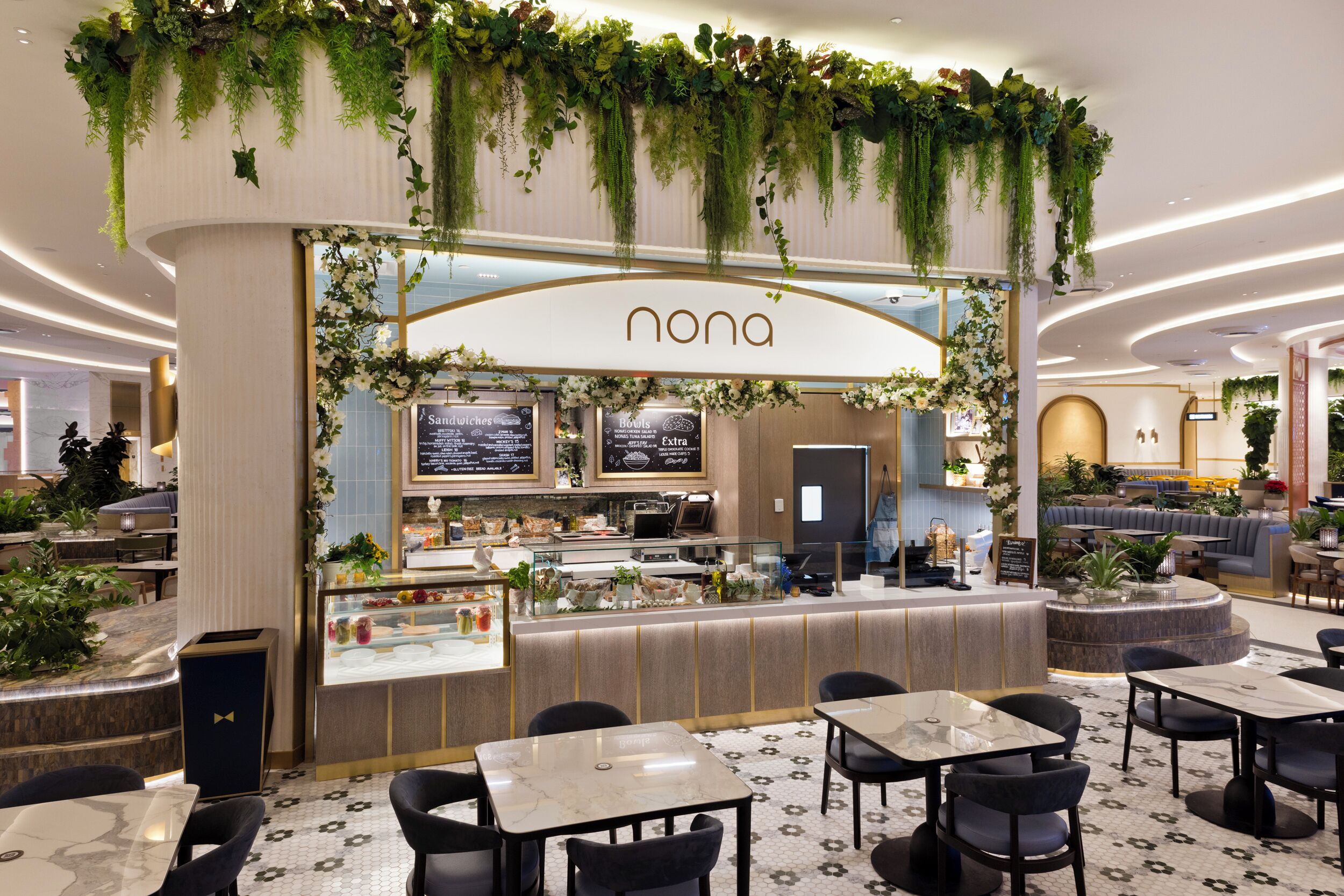 A restaurant with a modern design, featuring a counter with a menu, and surrounded by seating areas.