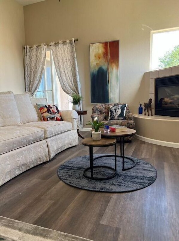 Relax in this stylish living room with a comfortable sofa, coffee table, and fireplace.