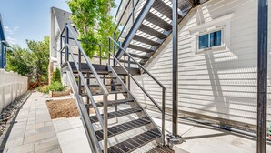 A modern building with a metal staircase leading to a second floor. - 14 Mi to Dtwn Denver: Sleek Westminster Home (Westminster)
