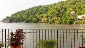 A river with a lush green hillside in the background.