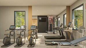 A modern gym with treadmills, elliptical machines, and a weight bench. - Gated Community  - Near Disney (Kissimmee)