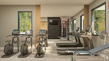 Une salle de sport moderne équipée de tapis de course, de vélos elliptiques et d’un banc de musculation.