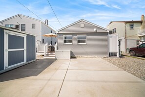 A residential area with a garage, a covered patio, and a driveway. - Beach Bungalow -- 1.5 Blocks to Beach! (Brigantine)