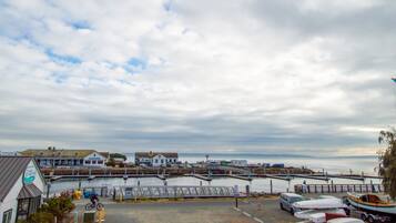 A coastal town with a marina, a bridge, and buildings along the waterfront.