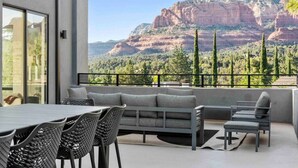 A balcony with a view of red rock formations and trees. - Ultimate Uptown Home Epic Views Private Pool and Spa (Sedona)