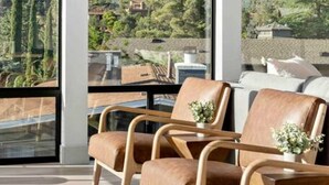 A modern living room with large windows offering a view of a canyon landscape. - Ultimate Uptown Home Epic Views Private Pool and Spa (Sedona)