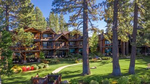 A large lodge with multiple guest rooms, a covered outdoor seating area, and a well-maintained garden. - 8 Sierra Shores - Stunning Lakefront 4BR/4BA (South Lake Tahoe)