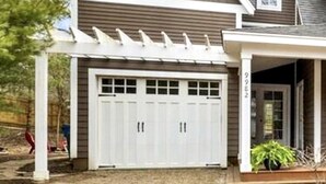 A two-story house with a covered garage, a small porch, and a visible address number. - Modern Lakeshore Home! 2 minute drive to the beach! Community pool 3 houses away (Union Pier)