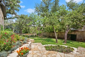Stroll through the garden, surrounded by a variety of plants and a meandering stone pathway.
