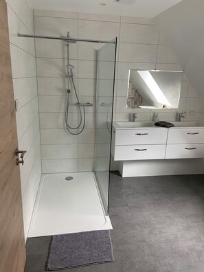 Shower, hair dryer, towels, toilet paper