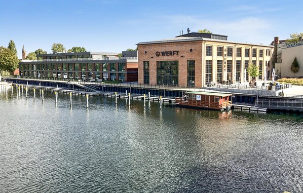 A waterfront building with a dock and a boat.
