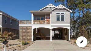 A two-story house with a covered garage and a small porch.