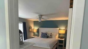 A bedroom with a bed, bedside tables, a ceiling fan, and a nightstand. - #3 Bright 1-Bdrm suite downtown with parking (Saugatuck)