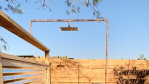 A wooden sauna with a slatted wall, a metal pipe, and a solar panel. - Stardust on the Mesa...A Breathtaking Experience (Yucca Valley)