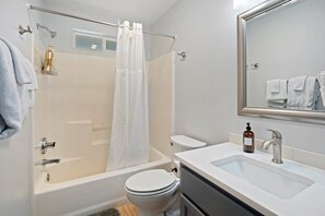 Tina con regadera, secadora de cabello, toallas 