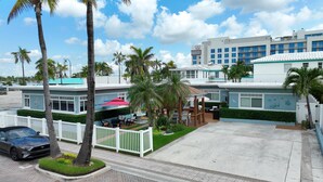 A hotel with a pool area, outdoor seating, and palm trees. - Tropic Isle Boutique Hotel  (Hollywood)