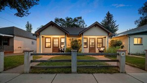 A two-story residential building with a front porch, a small attached garage, and a well-maintained lawn. - Quaint Heart of Downtown Flagstaff Unit w/Spa & AC (Flagstaff)