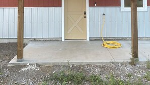 A red building with a beige door and the number 200 on the front. - Amazing views close to friends, family and fishing. Indoor RV parking 29’ max.  (Council)