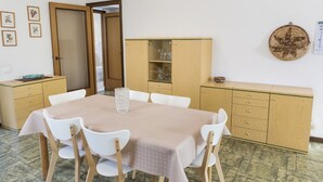 A dining area with a table, chairs, and cabinets. - A28 - Poggio, large three-room apartment with porch (Poggio)