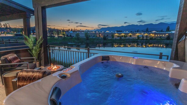 Un jacuzzi con vistas a un lago y montañas.