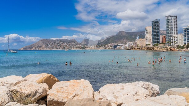 A coastal cityscape with clear blue waters, rocky shoreline, and modern buildings. - CostaBlancaDreams - Alexia in Calpe (Calpe)