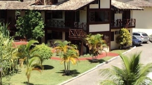 A two-story building with a traditional architectural style, featuring balconies and a tiled roof.