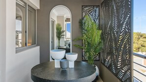 A modern bathroom with a round black marble sink, three white ceramic bowls, and a large mirror. - Modern Port Coogee Luxury Home (North Coogee)