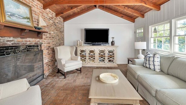 Una sala de estar acogedora con chimenea, televisor y asientos cómodos.