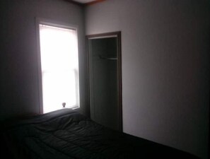 Cozy retreat with a single bed and a door leading to another area.