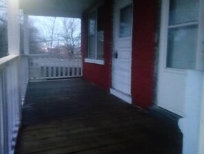 Step out onto the covered porch and enter through the welcoming white door.