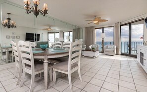 Enjoy ocean views from the large windows in this room, which features a dining table and comfortable seating for meals.
