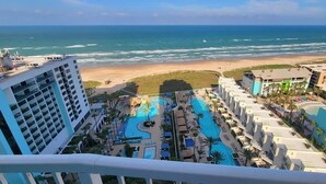 A resort with multiple swimming pools, a beach view, and high-rise buildings. - Sapphire 1706 3 Bedroom Home by RedAwning (South Padre Island)
