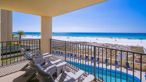 A balcony with a view of a beach and pool. - Phoenix Iv 4023 3 Bedroom Condo (Orange Beach)