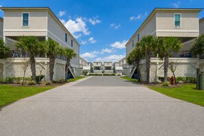 A row of two-story buildings with a central paved walkway.