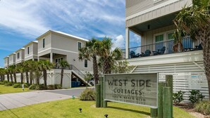 A row of West Side Cottages with a sign indicating the address 1592 W. Beach Blvd. - West Side Cottages N 3 Bedroom Home (Gulf Shores)