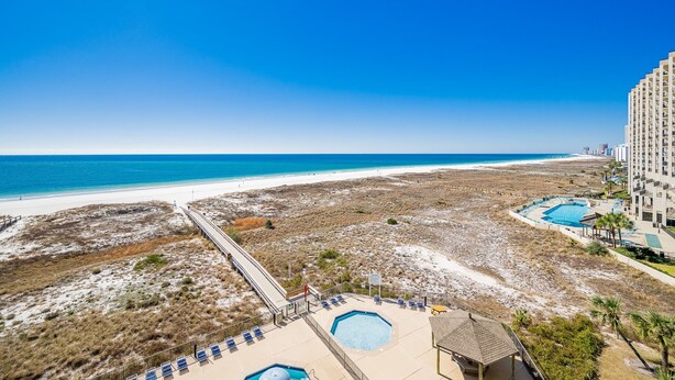 A beachfront hotel with a pool, beach access, and a view of the ocean. - Phoenix Viii 8604 3 Bedroom Condo (Orange Beach)
