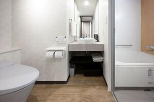 Un baño moderno con inodoro, lavamanos y bañera.