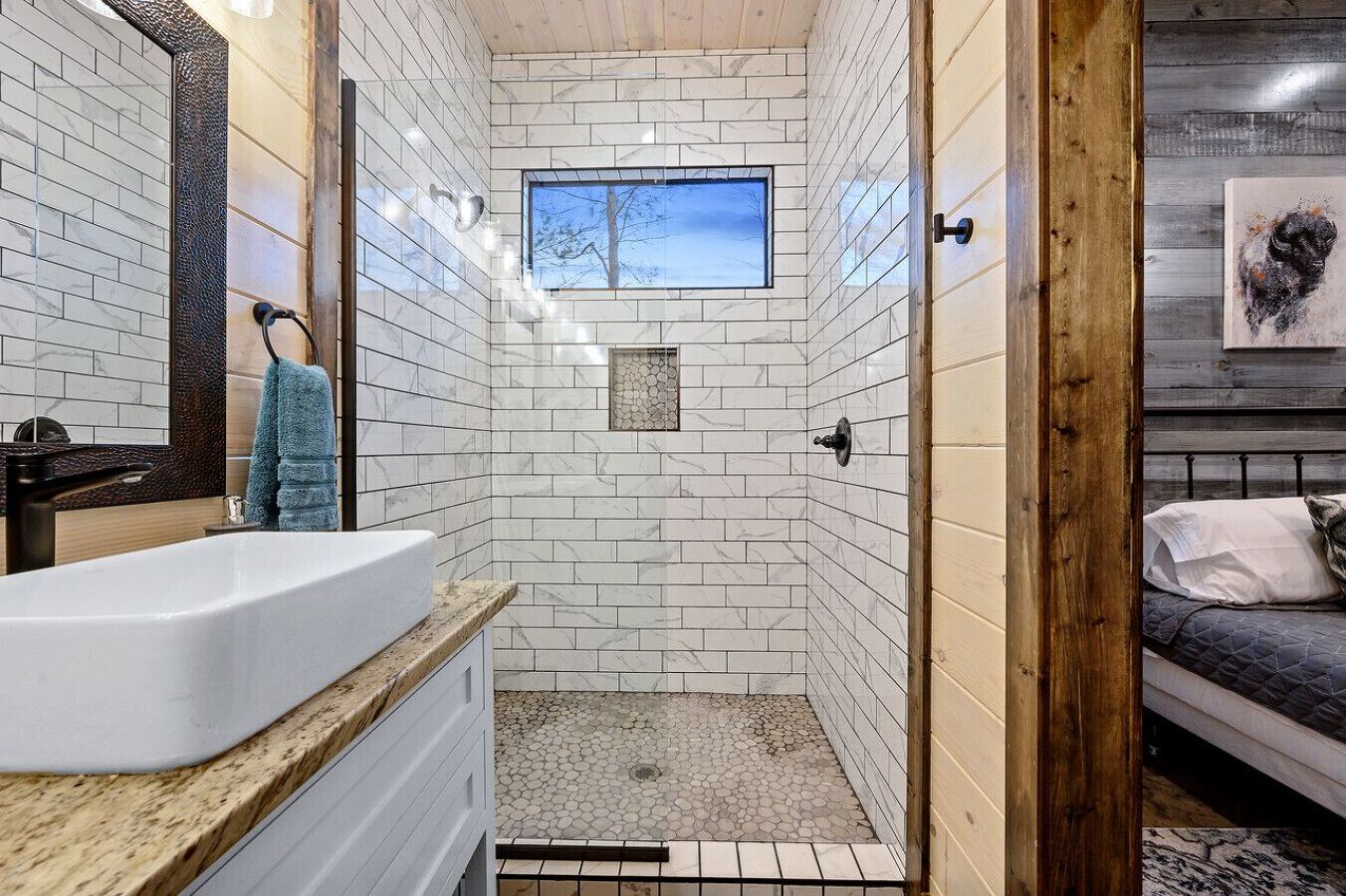 A bathroom with a bathtub, a shower, and a window.