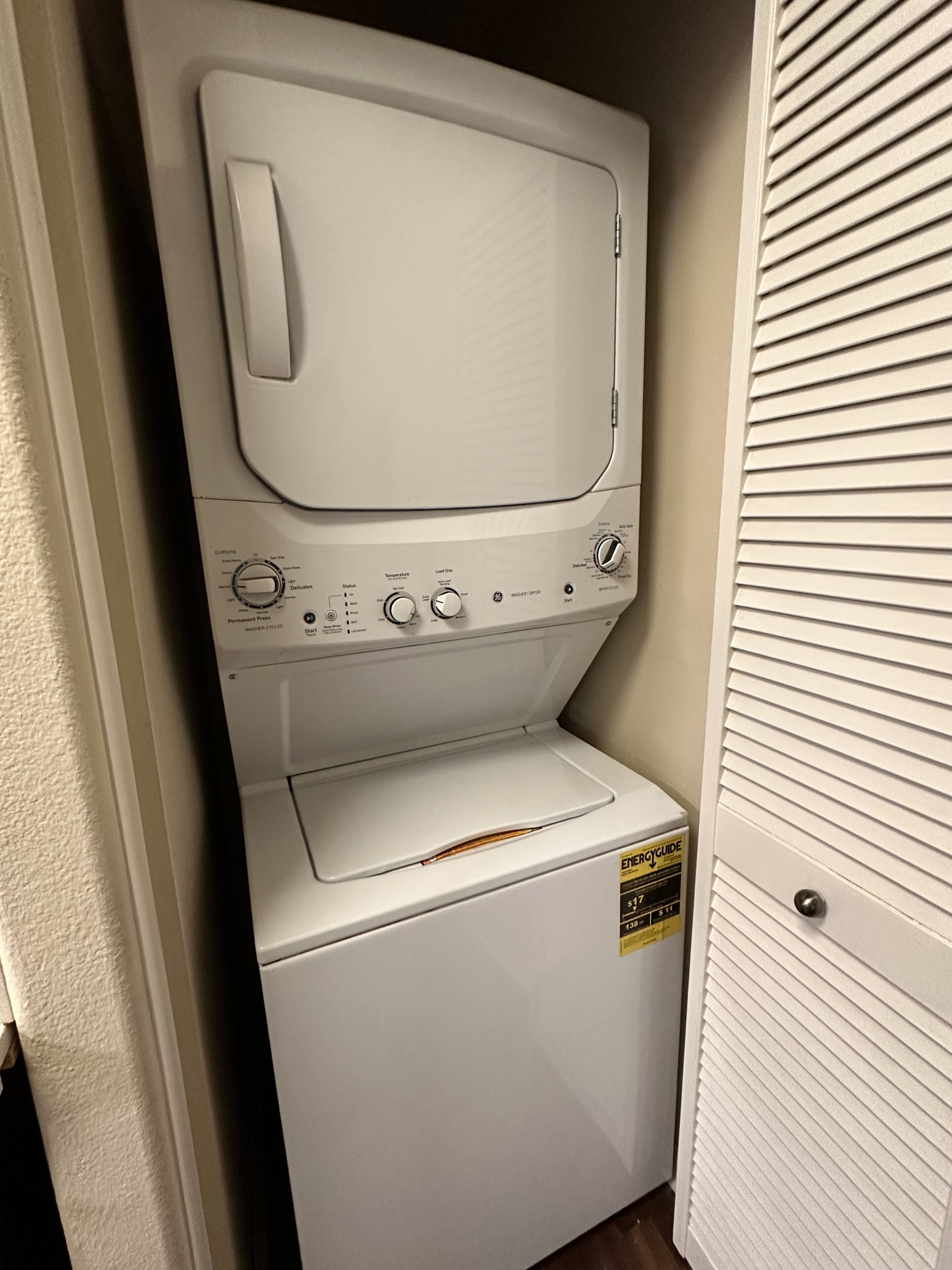 A compact washer and dryer unit with a control panel, a detergent dispenser, and a water level indicator.