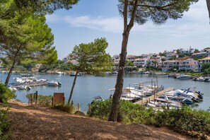 A marina with boats docked, surrounded by residential buildings and trees. - Fabulous Villa with Private Pool in Tranquil Area, Sleeps 8 (Cala Molí)