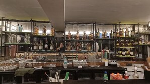 A bar with shelves of liquor bottles and glasses. - HOTEL PARK ROYAL  (Panchkula)
